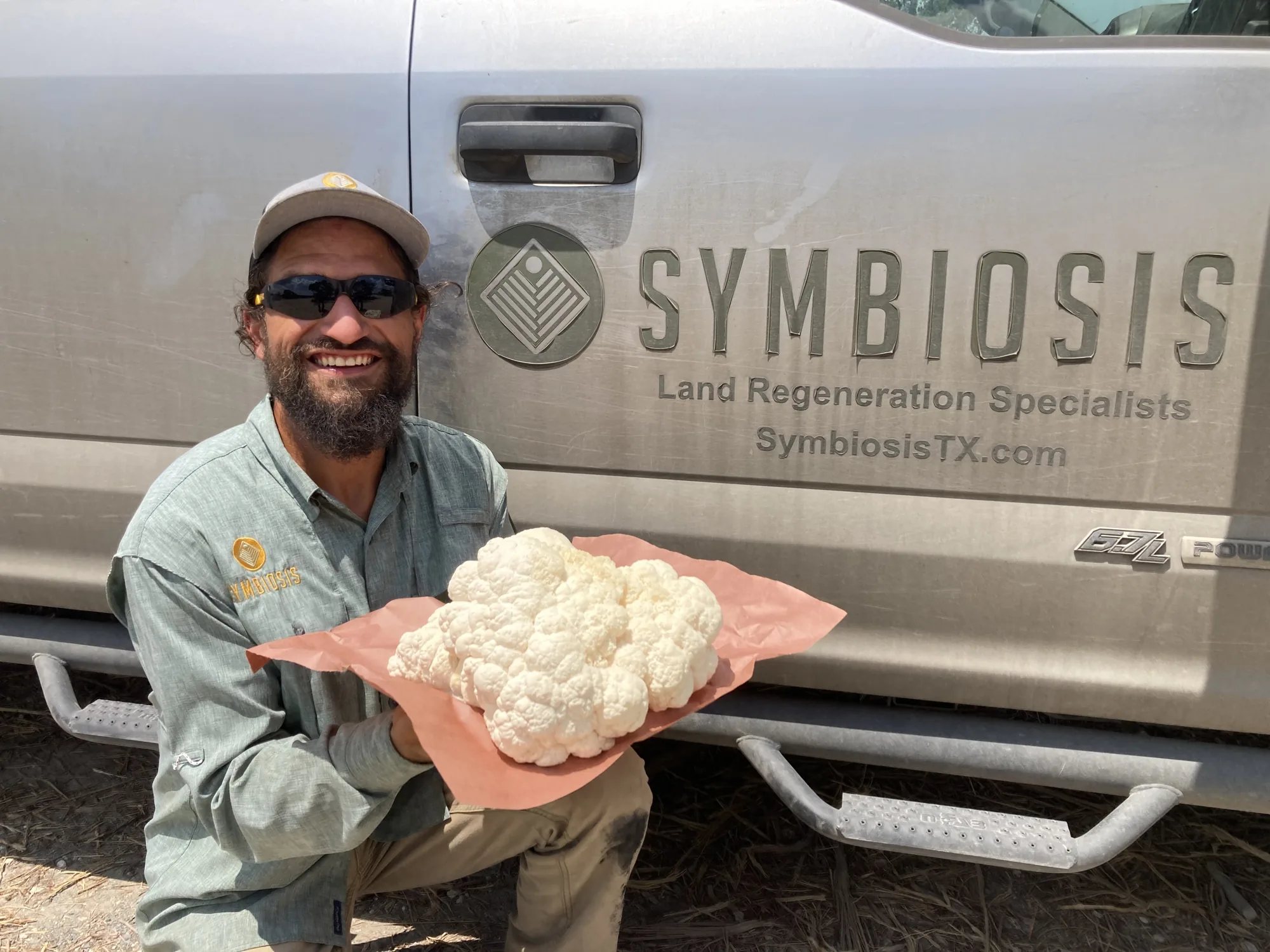 Sam the Fungi holding a freshly harvested lion's mane mushroom